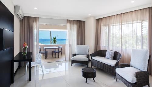 a living room with a couch and chairs and a table at Tanoa International Dateline Hotel in Nuku‘alofa