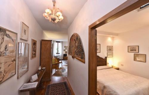 a bedroom with a large bed and a chandelier at San Marco Garden House in Venice