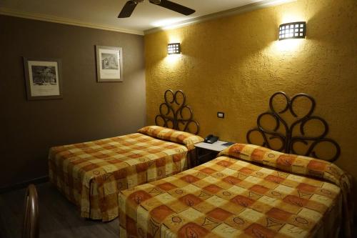 Postel nebo postele na pokoji v ubytování Hotel Plaza Crystal
