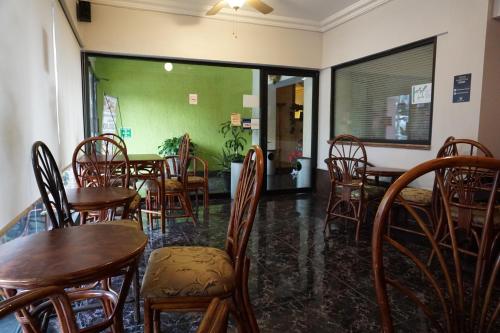 a dining room with wooden tables and chairs at Hotel Plaza Crystal in Xalapa
