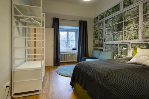a bedroom with a bed and a book shelf at Blue flat by GrazRentals best location & free parking in Graz