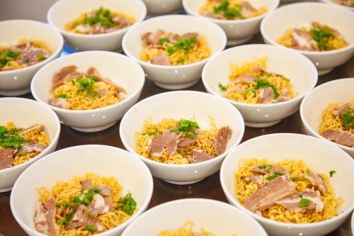 a group of white bowls filled with food at Golden Rose Hotel in Da Nang