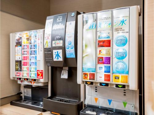 a gas station with three refrigerators in a store at Super Hotel Hachinohe Tennen Onsen in Hachinohe