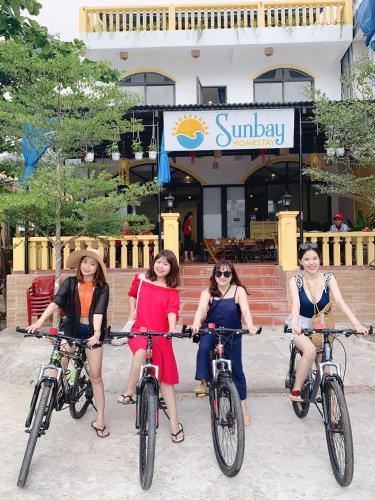 a group of women riding bikes in front of a restaurant at Sunbay Homestay Cu Lao Cham in Tân Hiệp