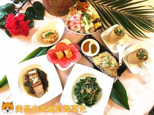 a table filled with different types of food on plates at Melon Shan Spa World in Liugui