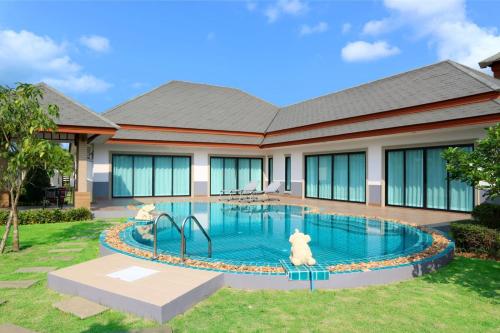 a swimming pool with two dogs sitting in it at Dusit Garden Large Pool Villa in Na Jomtien
