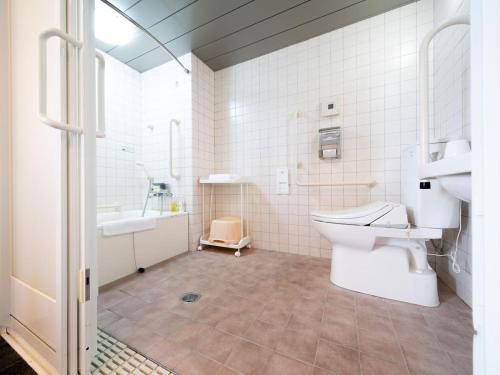 uma casa de banho com um WC, um lavatório e uma banheira em Super Hotel Towada Natural Hot Springs em Towada
