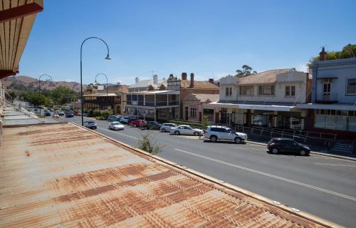 a city street with cars parked on the road at Criterion Hotel Gundagai in Gundagai