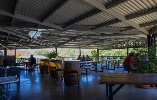 a patio with tables and chairs and people sitting at tables at Criterion Hotel Gundagai in Gundagai