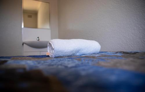a towel sitting on top of a bed in a bathroom at Criterion Hotel Gundagai in Gundagai