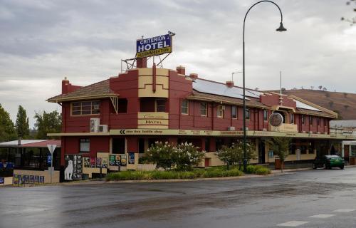 a red hotel with a sign on top of it at Criterion Hotel Gundagai in Gundagai