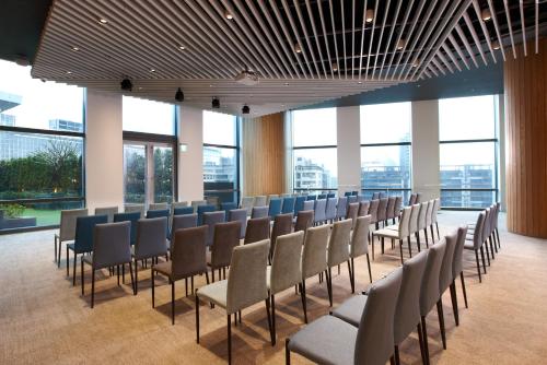a row of chairs in a room with windows at The Place Taipei in Taipei