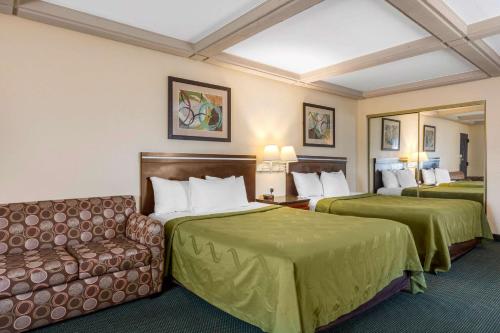 a hotel room with two beds and a couch at Quality Inn Lomita-Los Angeles South Bay in Lomita