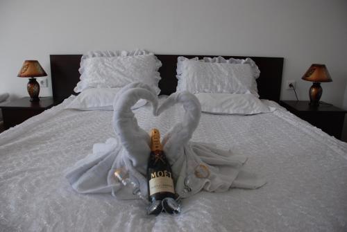a bed with two swans made out of towels at Elegant Lux Hotel in Bansko