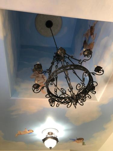 a chandelier hanging from a ceiling with people on it at Casa Del Sol in Carpinteria