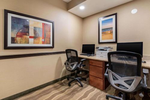 an office with a desk with a computer and two chairs at Comfort Suites Atlantic City North in Absecon