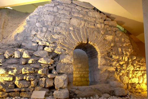 a stone oven in a room with a stone wall at Hotel Golden Tulip Varna in Varna City