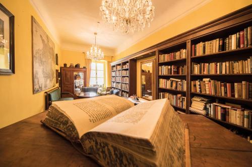 a room with a large bed with a book at Schlosshotel Mondsee in Mondsee