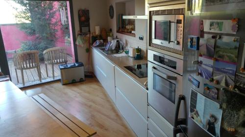 a kitchen with a counter and a refrigerator with magnets at Casa Ruiz in Ayerbe