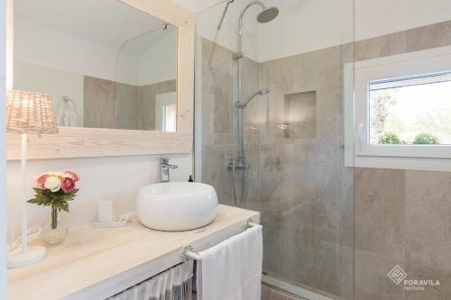a bathroom with a sink and a shower at Can Marc in Vilafranca de Bonany