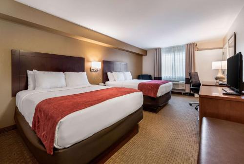 a hotel room with two beds and a television at Comfort Suites Atlantic City North in Absecon