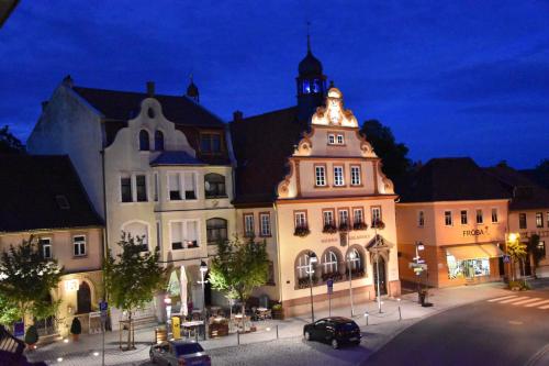 a large building with a clock tower on top of it at Ferienzimmer Therme Natur - Ferienhaus "Zum Goldenen Löwen" in Bad Rodach