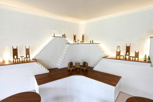 a dining room with a table and a staircase at Hotel Labaris Khao Yai in Mu Si