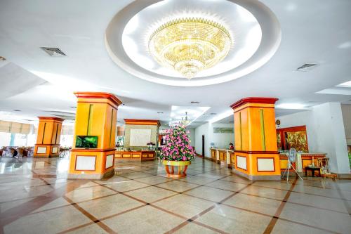 a lobby with a christmas tree in a large building at NGAN HA HOTEL in Ðại Tiêt
