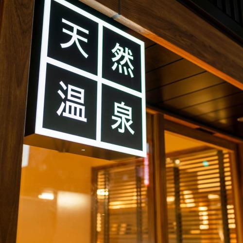a sign on a building with chinese writing on it at Super Hotel Premier Ginza in Tokyo