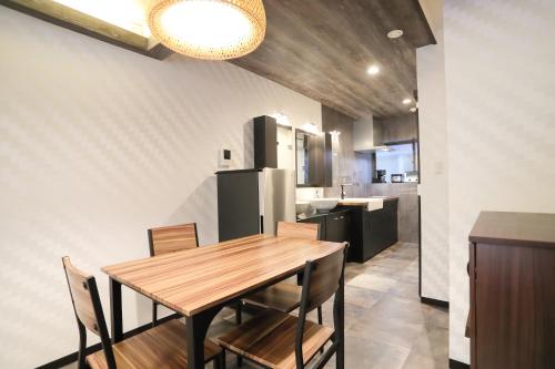 a kitchen and dining room with a wooden table and chairs at Villa Ikebukuro in Tokyo