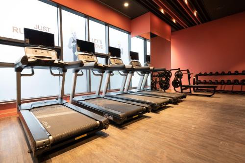 a row of treadmills in a gym at Lavalse Hotel in Busan