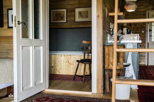 an open door to a room with a kitchen at Zielna Farma in Blanki