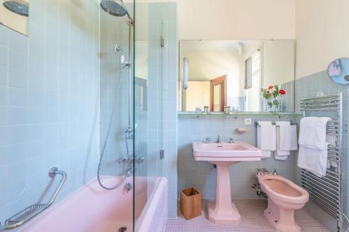 a bathroom with a sink and a toilet and a shower at Le Grand Hôtel in Molitg les Bains