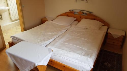 1 Schlafzimmer mit 2 Betten und weißer Bettwäsche in der Unterkunft Gasthaus Schug-Müller in Flacht