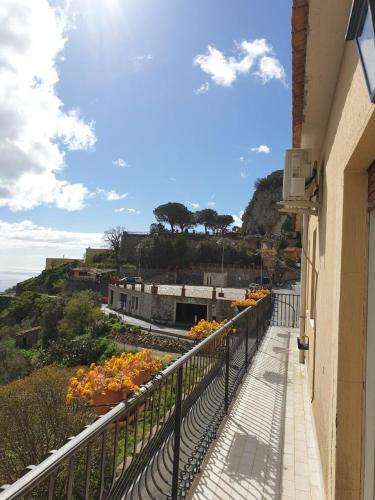 a balcony with flowers on the side of a building at Casa "Rocca di Mola" in Castelmola