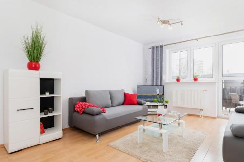 a living room with a couch and a table at Apartments Świnoujście Center III by Renters in Świnoujście