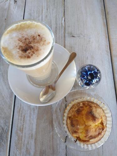 a cup of coffee and a pie on a table at Zhimbad B&B by the sea in Cala Ratjada
