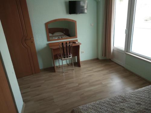 a room with a desk with a mirror and a television at Apartments Center in Sandanski