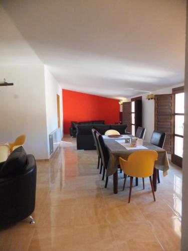 a living room with a table and chairs at Puerta del Arco in Riópar