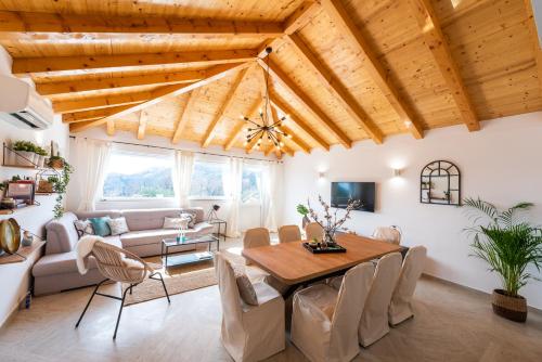 a living room with a wooden ceiling and a table at Villa Paulina in Mlini
