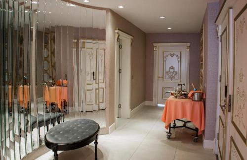 a dressing room with a table and a chair in a room at Euphoria Batumi Convention & Casino Hotel in Batumi