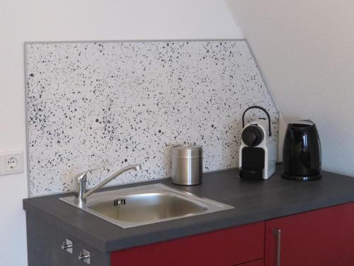 a kitchen counter with a sink and a wall at Logement Gieten in Gieten