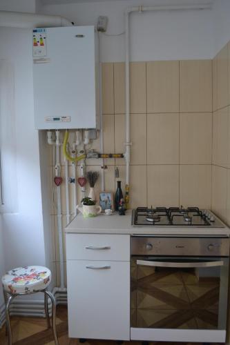a kitchen with a stove and a white counter top at Relax Apartament in Constanţa