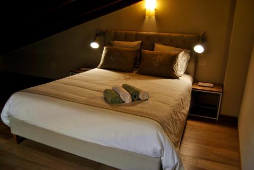 a bedroom with a large bed with two pillows at Appartamento Le Corti in Pistoia