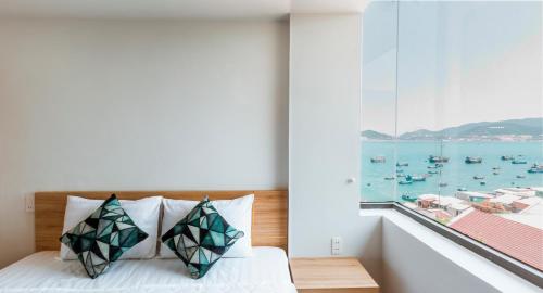 a bedroom with a window with a view of the water at AQUA Seaview Hotel in Nha Trang