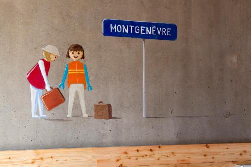 a stick figure of a man and a woman under a street sign at Anova Hotel & Spa in Montgenèvre