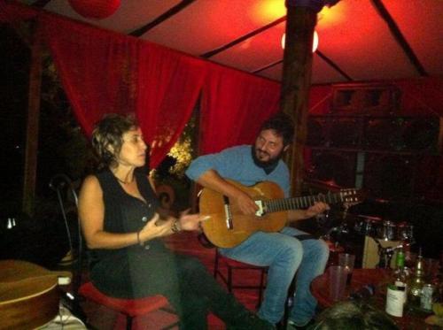 a man and a woman playing a guitar in a room at Apartamentos la Jayma del Arte in Asque