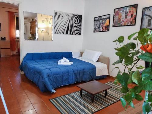a bedroom with a blue bed and a table at Piazzadarmi 26 in Ancona