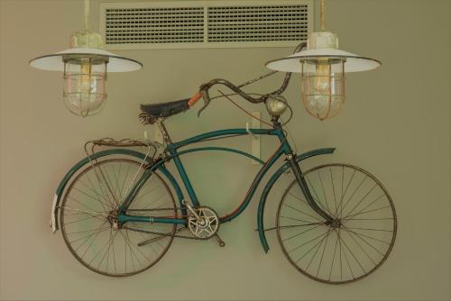 a bike is attached to a wall with lights at Herdade do Ananás in Ponta Delgada