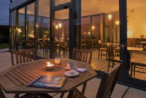 a wooden table with a candle on a patio at Herdade do Ananás in Ponta Delgada